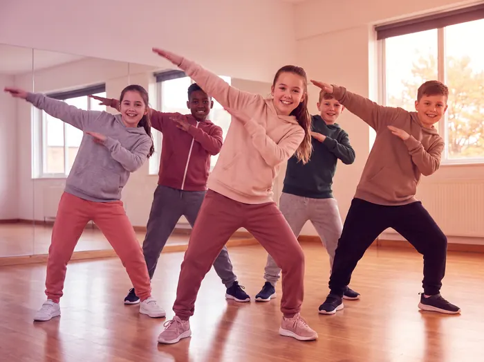 A group of kids hitting a hip hop pose together